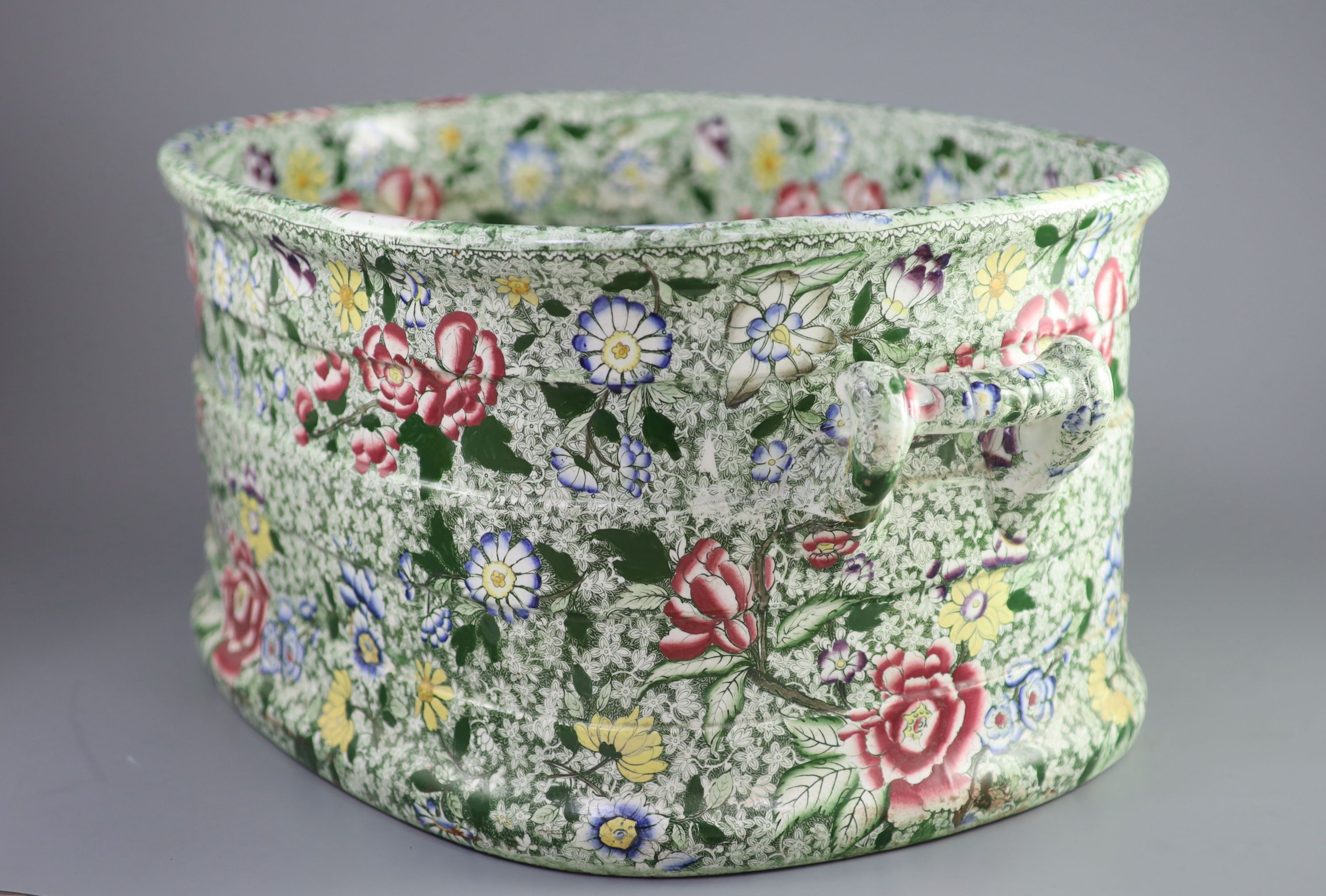A Victorian ironstone two handled footbath, c.1840, 53cm across